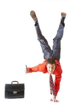 Image of businessman keeping himself on one arm while showing thumb up by another hand
