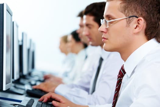 Smart businessmen typing in line at workplaces