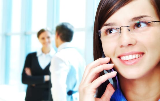 Photo of smart businesswoman calling with interacting people behind