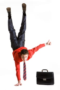 Image of businessman keeping himself on one arm while showing thumb up with another hand