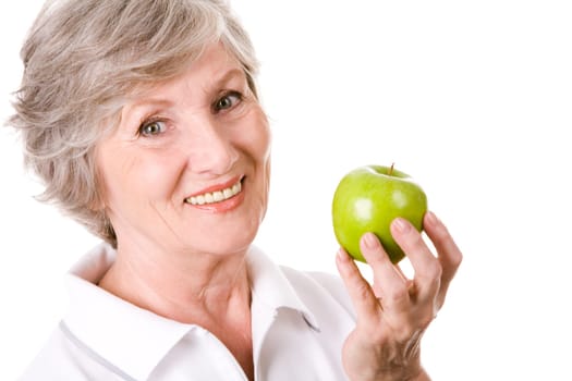 Portrait of mature woman smiling with green apple in hand