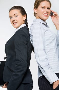 Portrait of two partners standing with their backs to each other