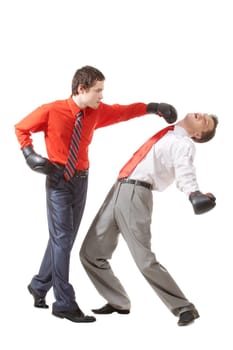 Portrait of aggressive businessman in boxing gloves kicking his rival