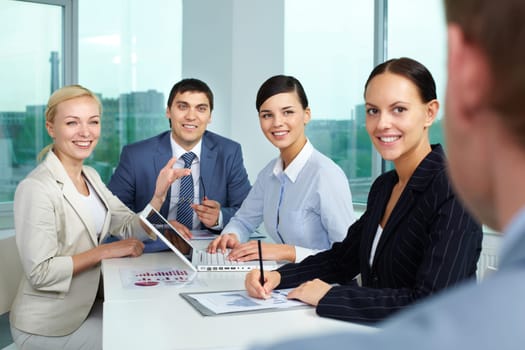Business people sitting in boarding room and communicating