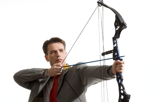 Portrait of concentrated male with crossbow in hands over white background