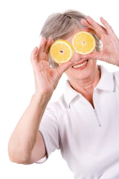 Portrait of mature woman smiling with lemon slices in front of her