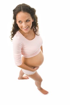 Above shot of pretty pregnant woman in tanktop and panties walking with smile