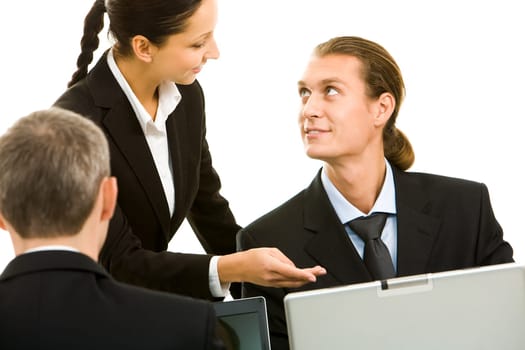 Portrait of executive employees looking at each other and communicating in office