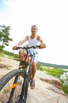 Sportive man riding mountain bike