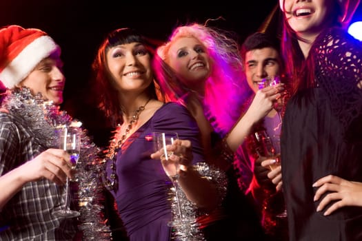 Image of joyful friends having fun at disco in night club at party