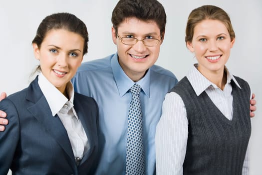 Happy boss takes in his arms colleagues