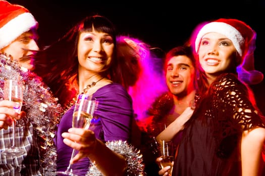 Image of joyful friends having fun at disco in night club at party