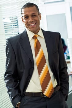 Portrait of successful boss looking at camera with smile in office