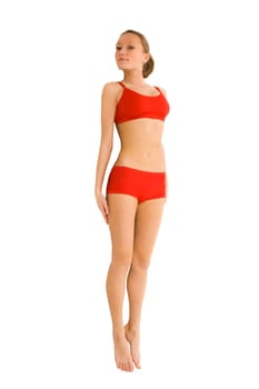 Portrait of healthy female in underwear keeping her hands on hips and smiling at camera