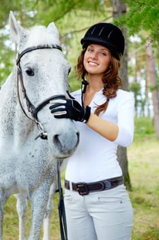 Image of happy female with purebred horse near by