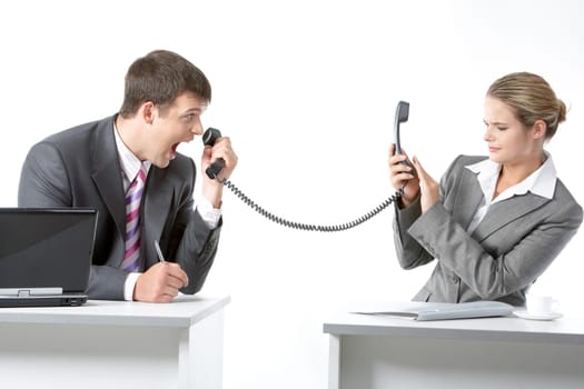 Portrait of angry boss shouting into telephone receiver at his secretary