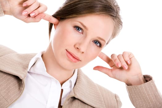 Image of pretty employee closing her ears with forefingers and looking at camerea with irritation