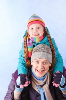 Image of happy man holding his daughter on shoulders