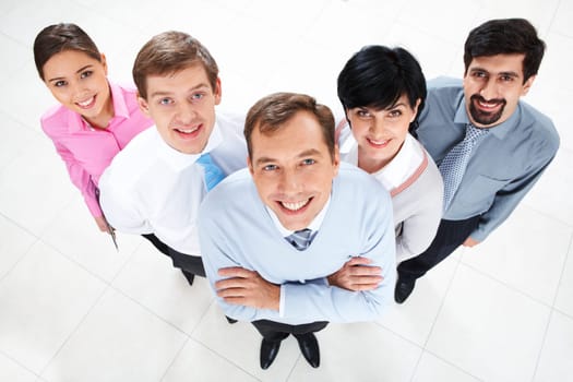 Above view of several successful partners looking at camera and smiling