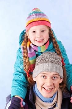 Image of happy man holding his daughter on shoulders