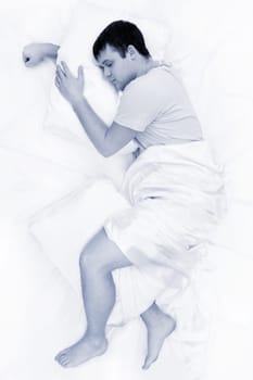 Black-and-white image of tired male having sweet dream at night