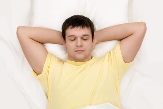 Image of tired man having sleep in comfortable bed after busy day