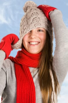 Portrait of cheerful teenage girl wearing warm knitted clothes