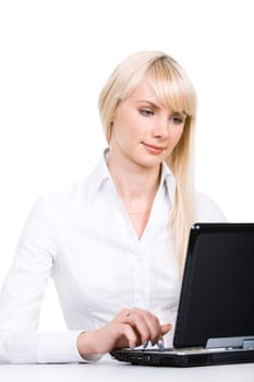 Portrait of blond woman sitting by laptop and working