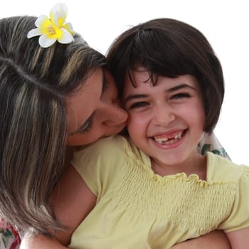 Details of a happy girl with her mother, isolated on white background. His mom wants her a little kiss