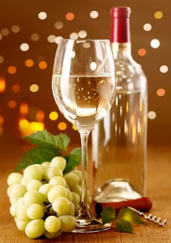 Elegant white wine with grapes on a festive background with beautiful Boketh