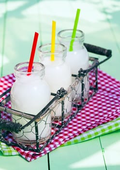 Different Milk Bottles in a tray on wooden board