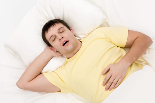 View from above of tired man snoring while deep sleep in bed