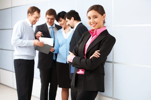 Photo of pretty business leader looking at camera in working environment