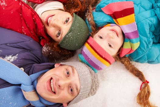 Above angle of happy family looking at camera