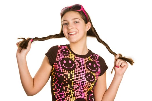 Portrait of cute girl with pony tails looking at camera over white background