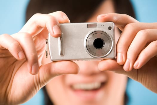 Image of photo camera in male hands ready to make a shot