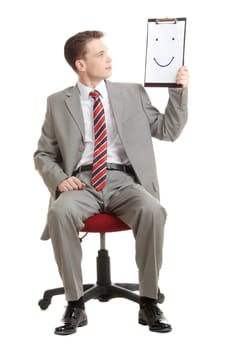 Portrait of businessman holding document with smile and looking at it