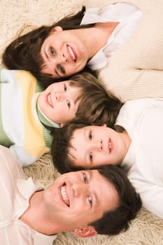 Above view of cheerful parents with their two children smiling at camera