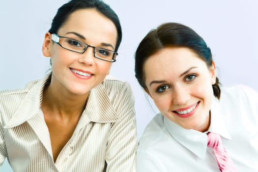 Portrait of smart business ladies looking at camera with smiles