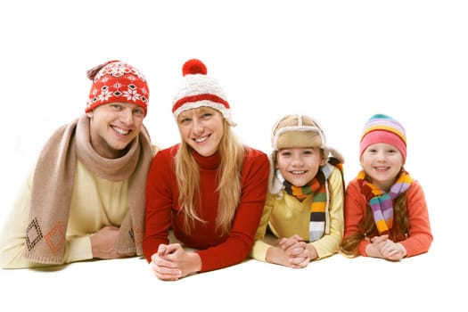 A family of four in warm clothing lying isolated on white