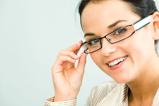 Face of gorgeous business woman touching her glasses