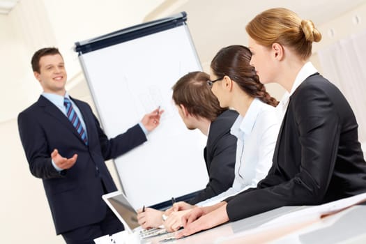Photo of successful businessman sharing ideas by whiteboard with partners at presentation