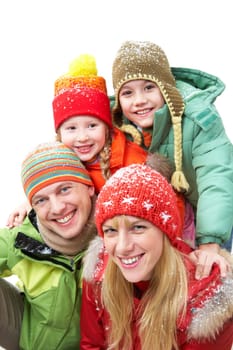 Happy family in winter clothes looking at camera and smiling