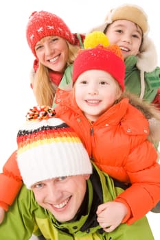 Heap of happy family members in winter clothing having fun