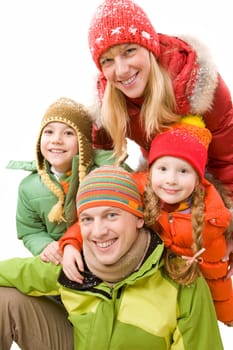 Happy family in winter clothes looking at camera and smiling