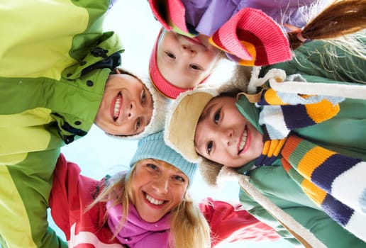 Below angle of happy family looking at camera