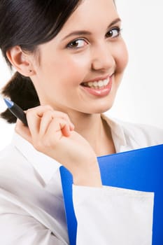 Close-up of happy girl with pen in hand smiling against white background
