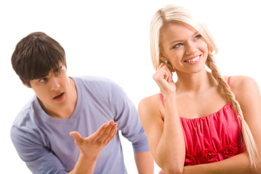 Happy woman smiling and looking aside on background of displeased man