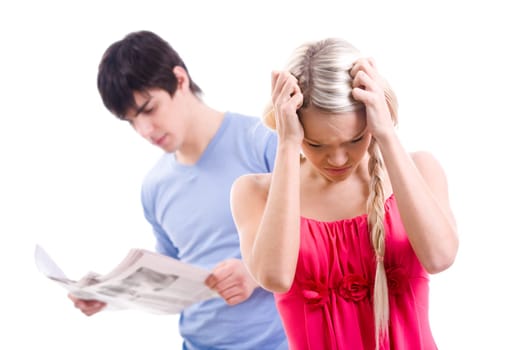 Stressed woman with touching her head on background of man reading paper