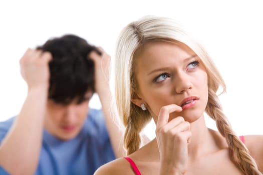 Sad woman with pensive expression thinking on background of her boyfriend